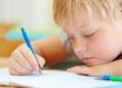 Fare i compiti: bambino fa i compiti con espressione svogliata