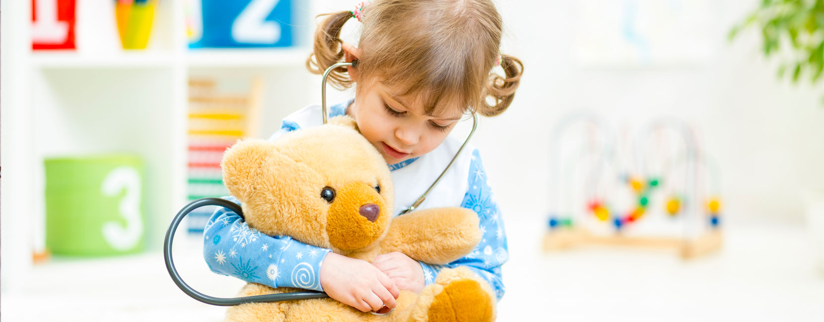 Bambina sente il cuoricino del suo orsetto con stetoscopio