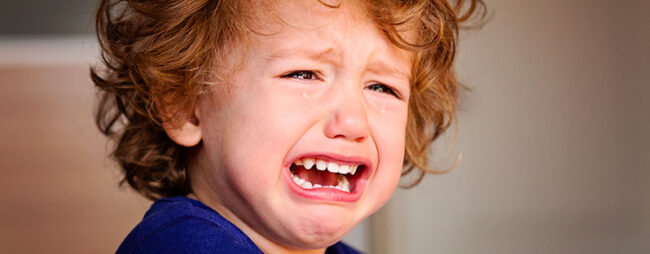 Bambino con crisi di pianto piange disperato