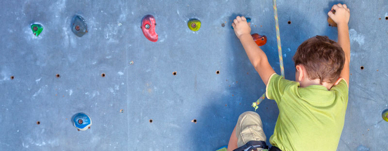 Bambino che si arrampica su una parete